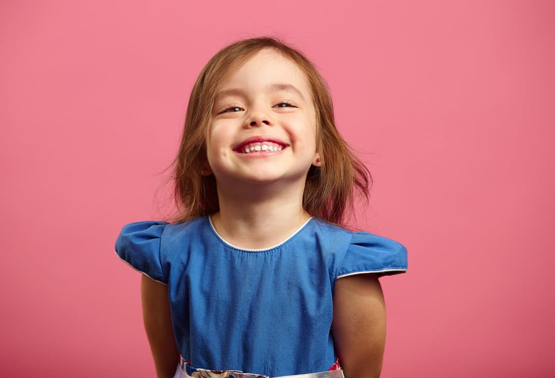 Child smiling in the dental chair during a pediatric checkup